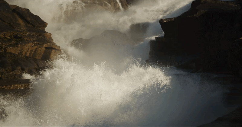 "Slow tilt up showing a massive waterfall cascading down a granite cliff face" from filmmaker Skip Armstrong. Footage licensed for Netflix's The Dinosaurs.